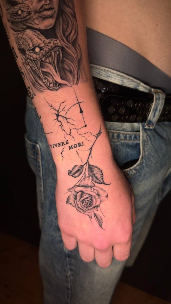 Rose and lettering hand tattoo