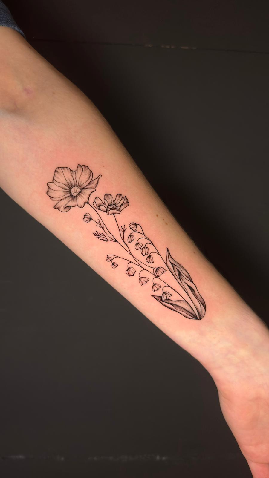 Fine line wildflower forearm tattoo